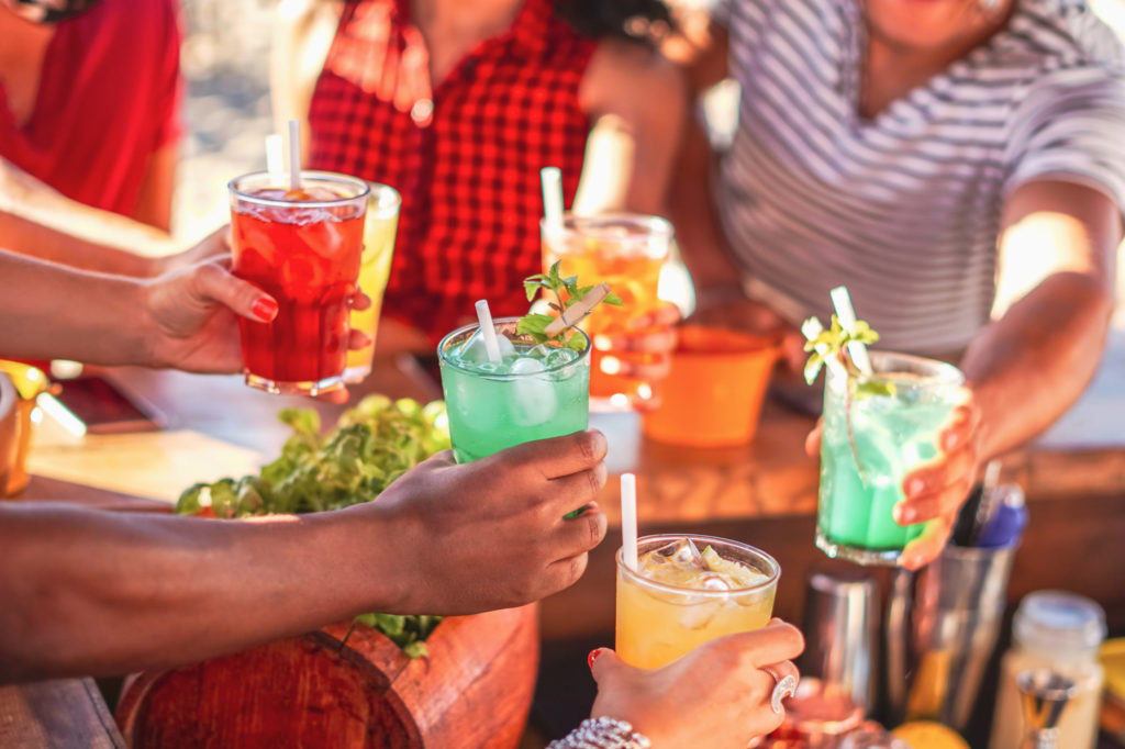 Happy people cheering with mojito and having fun - Multiracial f