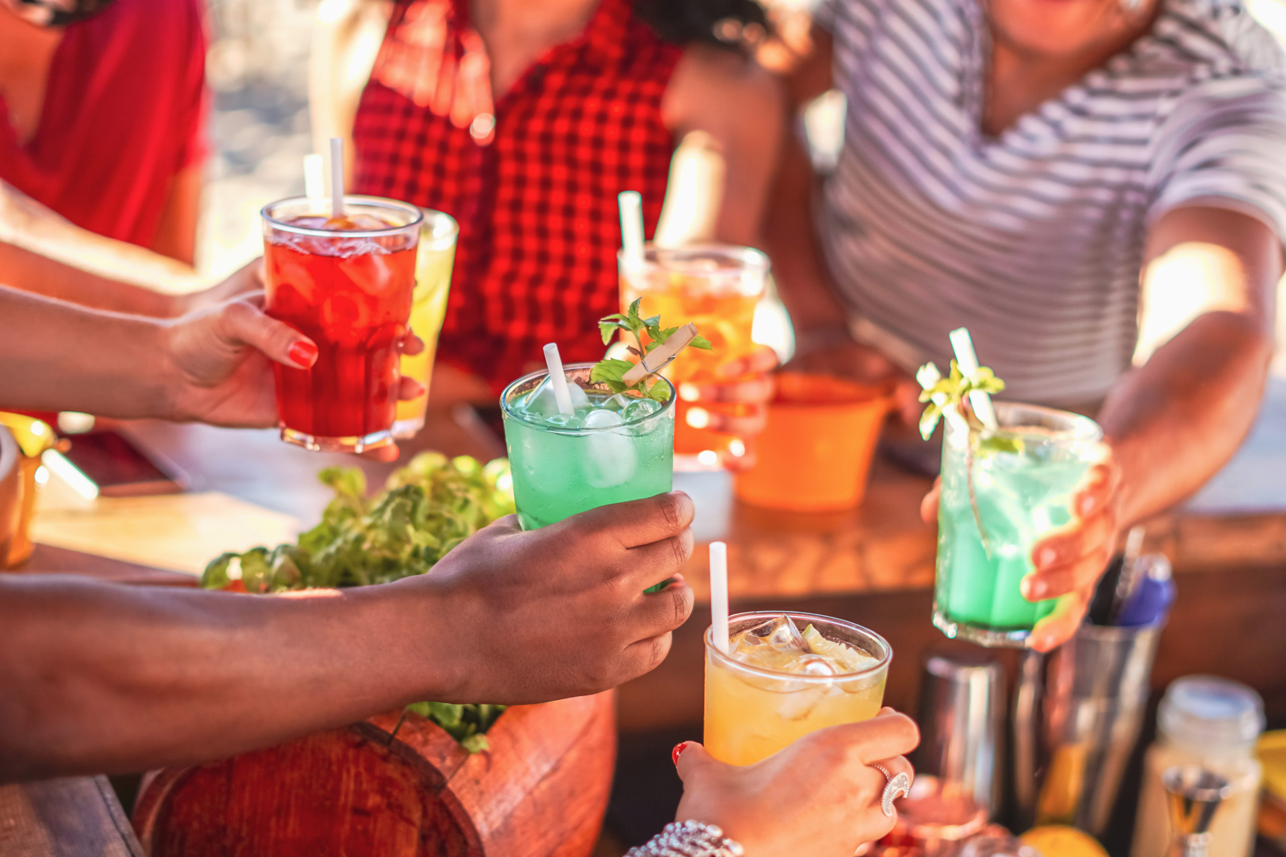 Happy people cheering with mojito and having fun - Multiracial f